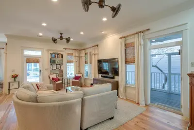 a living room with a couch and a tv at Out of Bounds in Santa Rosa Beach