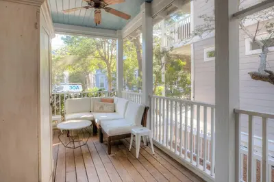 a screened porch with a couch and a table at Out of Bounds in Santa Rosa Beach