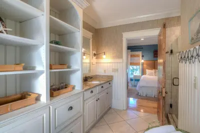a bathroom with white cabinets and a sink at Out of Bounds in Santa Rosa Beach