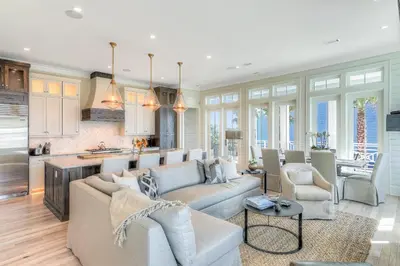 a living room with a couch and a kitchen at Patience Cottage in Santa Rosa Beach