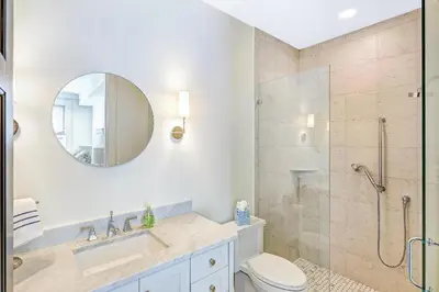 a bathroom with a shower and a toilet and a sink at Patience Cottage in Santa Rosa Beach