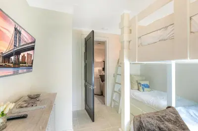 a bedroom with a bunk bed and a bunk room with a bunk bed at Patience Cottage in Santa Rosa Beach