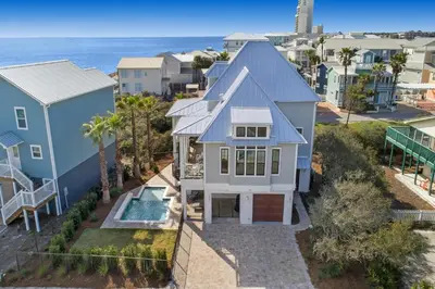 an aerial view of a house with the ocean in the background at Patience Cottage in Santa Rosa Beach