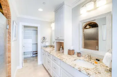 a white bathroom with two sinks and a large mirror at High Pointe 32W in Rosemary Beach