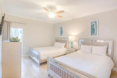 a bedroom with two beds and a ceiling fan at High Pointe 32W in Rosemary Beach