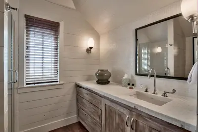 a bathroom with a large sink and a mirror at Gates Cottage in Rosemary Beach