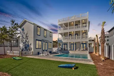 a large house with a swimming pool in a yard at Gilligan's Island in Inlet Beach