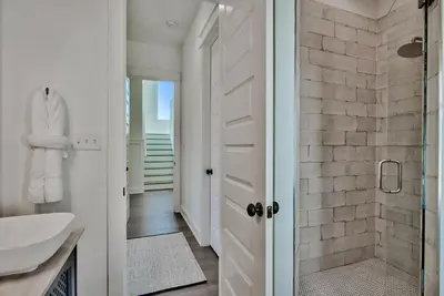 a bathroom with a shower and a sink at Gilligan's Island in Inlet Beach