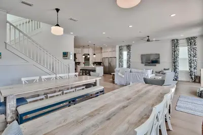 a living room with a wooden table and chairs at Gilligan's Island in Inlet Beach