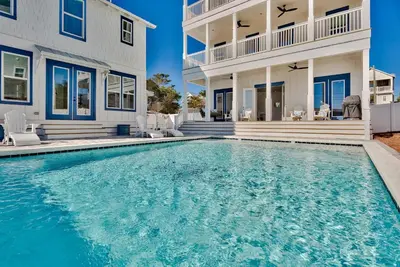 a swimming pool in front of a house at Gilligan's Island in Inlet Beach