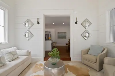 a living room with a couch and a chair at PTO Cottage in Rosemary Beach