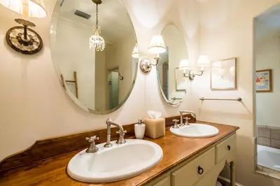 a bathroom with two sinks and a large mirror at Belize Cottage in Rosemary Beach