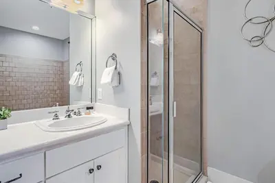 a bathroom with a sink and a shower at Percy's Flat in Rosemary Beach
