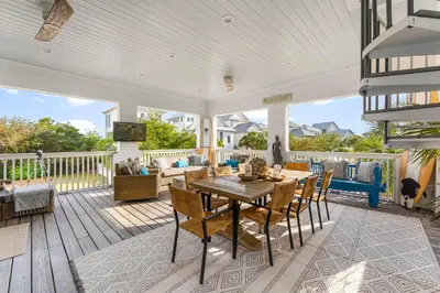 an open living room with a table and chairs at Seaspell Sands in Santa Rosa Beach
