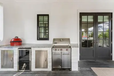 an outdoor kitchen with a stove and a door at Seaspell Sands in Santa Rosa Beach