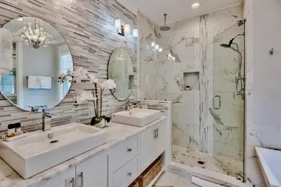 a bathroom with two sinks and a shower at Seaspell Sands in Santa Rosa Beach