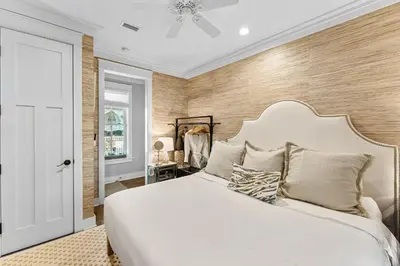 a bedroom with a large white bed and wooden walls at Seaspell Sands in Santa Rosa Beach