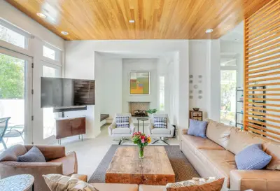a living room with a couch and a table at Astley Cottage in Rosemary Beach
