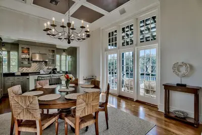 a kitchen and dining room with a table and chairs at Highland Cottage in Rosemary Beach