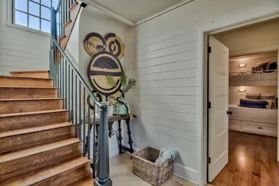 a staircase in a home with a mural on the wall at Highland Cottage in Rosemary Beach