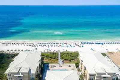 an aerial view of a beach with a group of people at Legacy Alexander at Palm Court in Seacrest