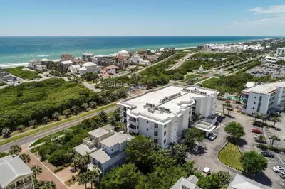 an aerial view of a city and the ocean at Legacy Alexander at Palm Court in Seacrest