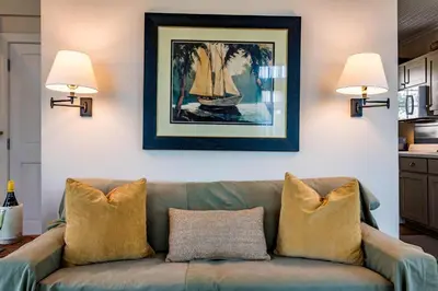a living room with a couch and a picture on the wall at Belize Carriage House in Rosemary Beach