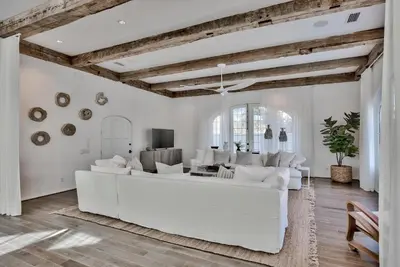 a white living room with a large white couch at Elysee Retreat in Seacrest