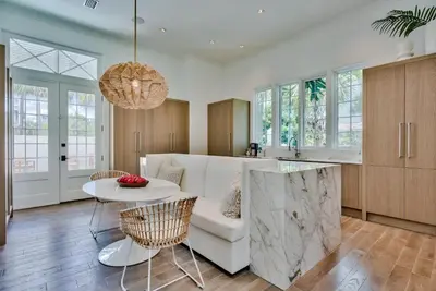 a kitchen with a white couch and a table at Elysee Retreat in Seacrest