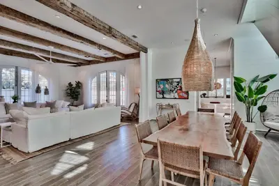 a dining room and living room with a table and chairs at Elysee Retreat in Seacrest