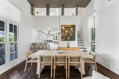 a dining room with a table and chairs at Acqua Cottage & Carriage House in Rosemary Beach