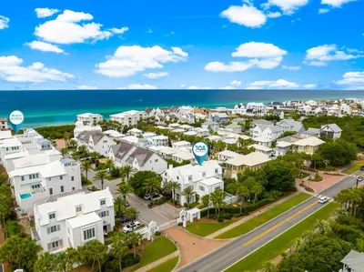 an aerial view of a city with houses and the ocean at Elysee Reunion in Rosemary Beach