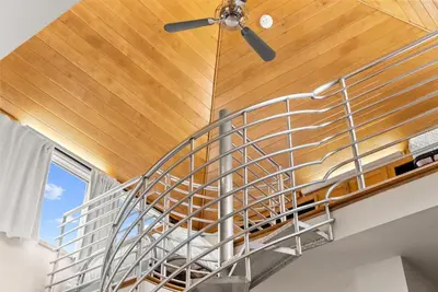 a spiral staircase in a house with a ceiling at Brighton Carriage House in Rosemary Beach