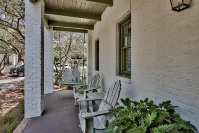 two chairs sitting on the porch of a house at Sylvia's Cottage in Rosemary Beach
