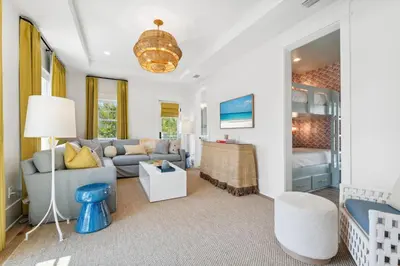 a living room with a couch and a bed at Beach Bear Cottage in Watersound Beach