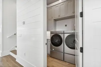 a white laundry room with a washer and dryer at Beach Bear Cottage in Watersound Beach