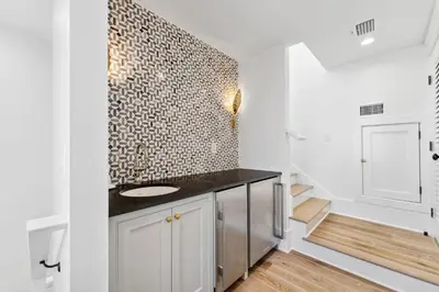 a bathroom with a sink and a wall at Beach Bear Cottage in Watersound Beach