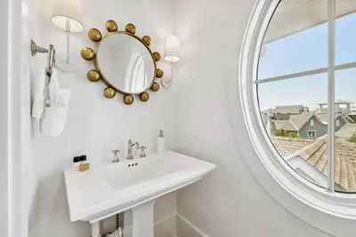 a bathroom with a sink and a mirror at Beach Bear Cottage in Watersound Beach