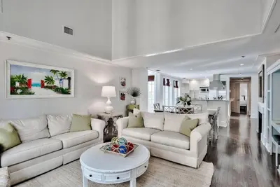 a living room with two couches and a table at Savannah 1E in Rosemary Beach