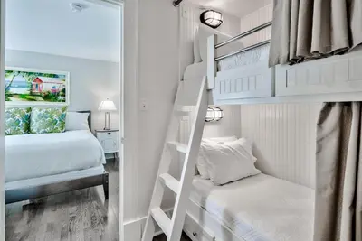 a bedroom with two bunk beds and a mirror at Savannah 1E in Rosemary Beach