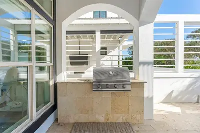 a grill on the outside of a house at Wilder Dreams in Seacrest