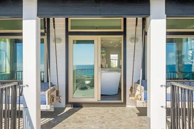 a front door of a house with a view of the ocean at Wilder Dreams in Seacrest