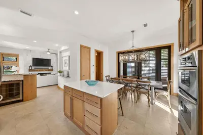 a kitchen and dining room with a table and chairs at Brighton Cottage in Rosemary Beach
