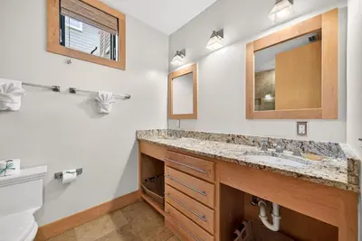 a bathroom with a sink and a mirror at Brighton Cottage in Rosemary Beach