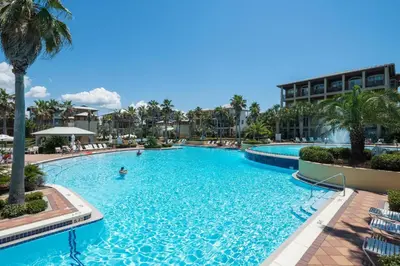 a pool at a resort with a person swimming in it at Flip Flop Dreams in Seacrest
