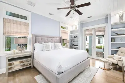 a bedroom with a bed and a ceiling fan at Butterfly Cottage in Rosemary Beach