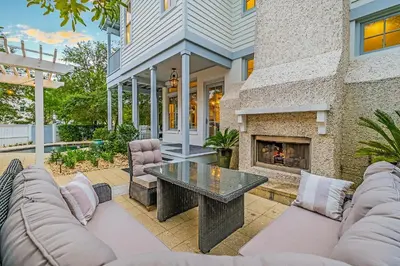 a patio with a fireplace in a house at Butterfly Cottage in Rosemary Beach