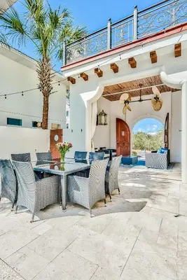 an outdoor patio with a table and chairs at Clare's Cottage in Seacrest