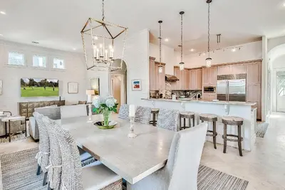 a dining room and kitchen with a table and chairs at Clare's Cottage in Seacrest