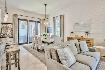 a living room with a couch and a table at Clare's Cottage in Seacrest